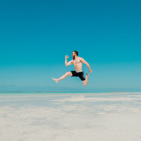happy-man-jumping-with-water-in-background
